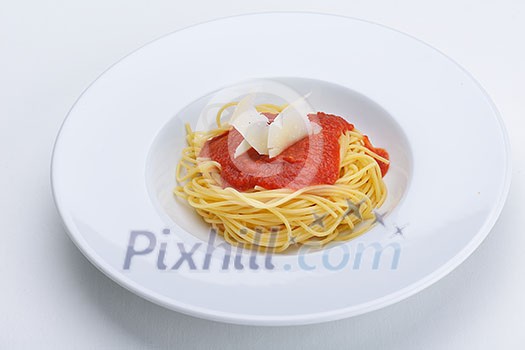 Italian spaghetti topped with bolognaise, or bolognese, sauce with tomatoes, meat and cheese on a plain white plate Italian spaghetti topped with bolognaise, or bolognese, sauce with tomatoes, meat and cheese on a plain white plate