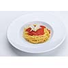 Italian spaghetti topped with bolognaise, or bolognese, sauce with tomatoes, meat and cheese on a plain white plate
