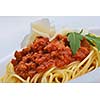 Italian spaghetti topped with bolognaise, or bolognese, sauce with tomatoes, meat and cheese on a plain white plate