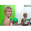 pretty woman with dumbbell