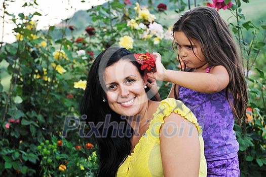 beautiful mom and daughter outdoor in garden together with flower have fun and hug beautiful mom and daughter outdoor in garden together with flower have fun and hug