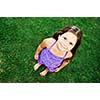 happy young girl children relax lie and have fun on grass with flower