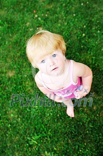 happy young girl children relax lie and have fun on grass with flower happy young girl children relax lie and have fun on grass with flower