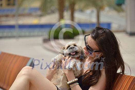 beautiful happy young woman in black dress with cute small dog puppy have fun on street beautiful happy young woman in black dress with cute small dog puppy have fun on street