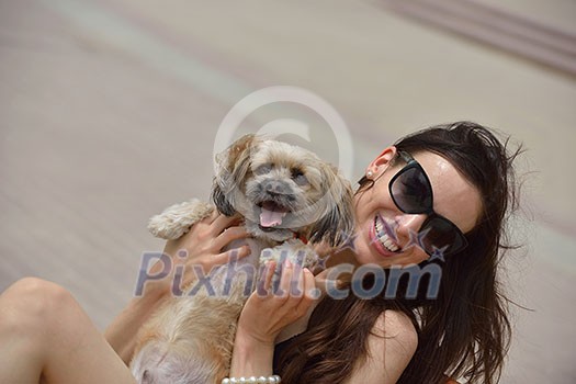 beautiful happy young woman in black dress with cute small dog puppy have fun on street beautiful happy young woman in black dress with cute small dog puppy have fun on street
