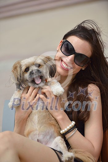 beautiful happy young woman in black dress with cute small dog puppy have fun on street beautiful happy young woman in black dress with cute small dog puppy have fun on street