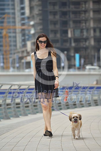beautiful happy young woman in black dress with cute small dog puppy have fun on street beautiful happy young woman in black dress with cute small dog puppy have fun on street