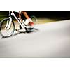 Cyclist on a road bike going fast (motion blur technique is used to convey movement; colour toned image)
