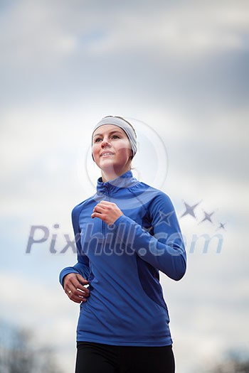 Portrait of a woman running against against blue sky Portrait of a woman running against against blue sky