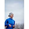 Portrait of a woman running against against blue sky