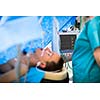 Unidentified boy undergoing a surgery. Focus on the monitor with vital functions