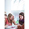 Group of college/university students during a brake between classes - chatting, comparing notes, having fun (shallow DOF; color toned image)