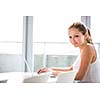 Portrait of a female university student/office worker using laptop at a library/office (color toned image; shallow DOF)