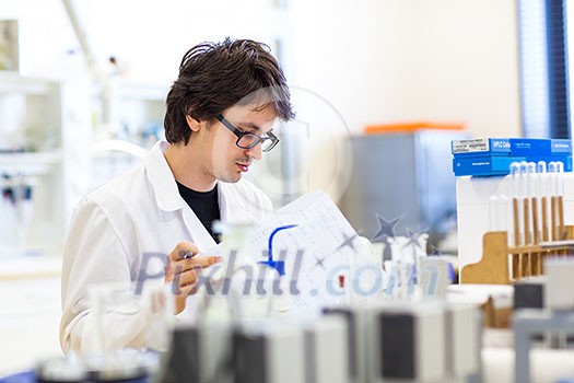 Male researcher carrying out scientific research in a lab (shallow DOF; color toned image) Male researcher carrying out scientific research in a lab (shallow DOF; color toned image)
