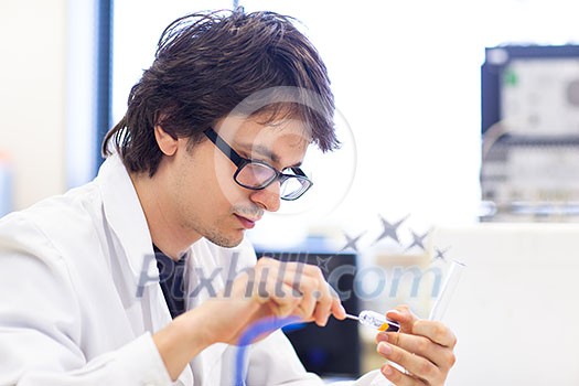 Male researcher carrying out scientific research in a lab (shallow DOF; color toned image) Male researcher carrying out scientific research in a lab (shallow DOF; color toned image)