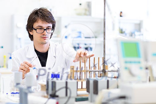 Male researcher carrying out scientific research in a lab (shallow DOF; color toned image) Male researcher carrying out scientific research in a lab (shallow DOF; color toned image)
