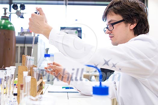 Male researcher carrying out scientific research in a lab (shallow DOF; color toned image) Male researcher carrying out scientific research in a lab (shallow DOF; color toned image)