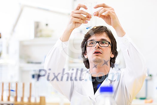 Male researcher carrying out scientific research in a lab (shallow DOF; color toned image) Male researcher carrying out scientific research in a lab (shallow DOF; color toned image)