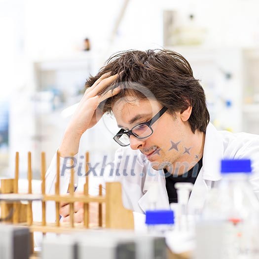 Male researcher carrying out scientific research in a lab (shallow DOF; color toned image) Male researcher carrying out scientific research in a lab (shallow DOF; color toned image)