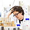 Male researcher carrying out scientific research in a lab (shallow DOF; color toned image)