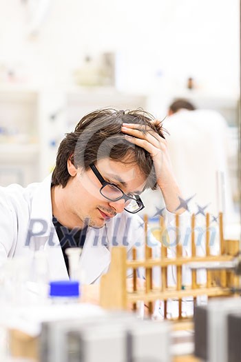 Male researcher carrying out scientific research in a lab (shallow DOF; color toned image) Male researcher carrying out scientific research in a lab (shallow DOF; color toned image)