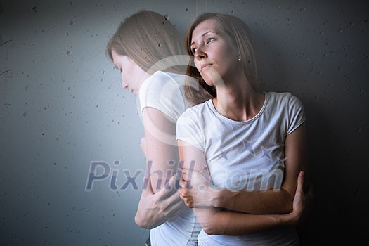 Young woman suffering from a severe depression/anxiety (color toned image; double exposure technique is used to convey the mood of unease, progression of the anxiety/depression) Young woman suffering from a severe depression/anxiety (color toned image; double exposure technique is used to convey the mood of unease, progression of the anxiety/depression)