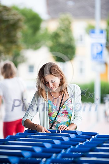 Beautiful young woman going shopping for groceries (color toned image)