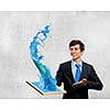 Handsome businessman holding frame with colorful splashes