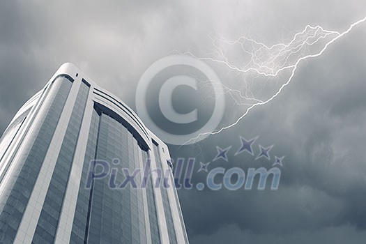 Bottom image of skyscraper with thunder lightning in sky Bottom image of skyscraper with thunder lightning in sky