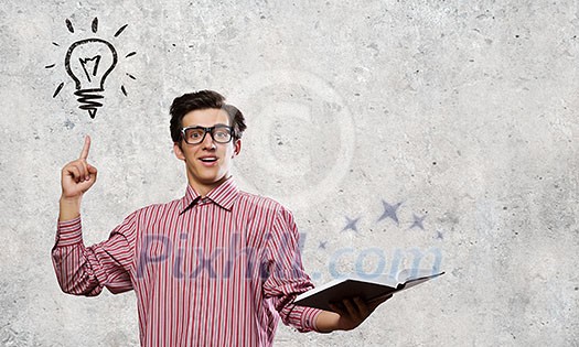 Young man in casual with book in hands Young man in casual with book in hands
