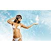 Young attractive girl in bikini wearing headphones touching media icon