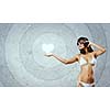 Young attractive girl in bikini wearing headphones touching media icon