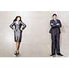 Bossy young businesswoman and handsome confident businessman