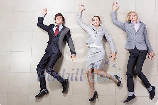 Young people in business suits lying on floor Young people in business suits lying on floor