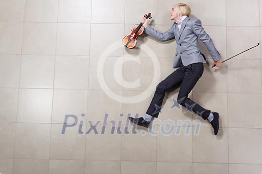 Funny image of running businessman with violin in hand Funny image of running businessman with violin in hand