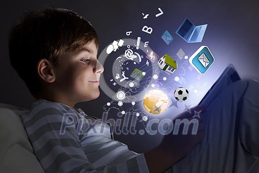 Little cute boy sitting in bed and using tablet Little cute boy sitting in bed and using tablet