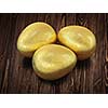 Three golden Easter eggs isolated on wooden background
