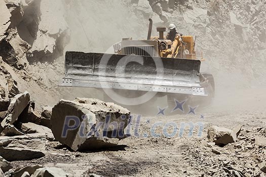 Bulldozer cleaning landslide from road in Himalayas. Himachal Pradesh, India Bulldozer cleaning landslide from road in Himalayas. Himachal Pradesh, India