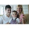 happy young family with kids in bright modern living room have fun and looking big flat lcd tv