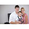 happy young family with kids in bright modern living room have fun and looking big flat lcd tv