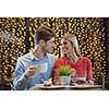 romantic evening date in restaurant  happy young couple with wine glass tea and cake