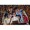 Group of happy people looking at a tablet computer