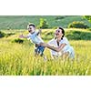 happy child and woman outdoor playing with soap bubble on meadow