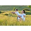 happy child and woman outdoor playing with soap bubble on meadow