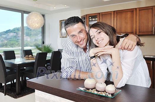happy young couple have fun in modern wooden kitchen indoor while preparing fresh food happy young couple have fun in modern wooden kitchen indoor while preparing fresh food
