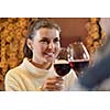 romantic evening date in restaurant  happy young couple with wine glass tea and cake
