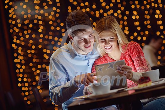 happy young couple with a tablet computer in restaurant happy young couple with a tablet computer in restaurant