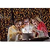 happy girls group  looking at a pc tablet in a home interior and have fun