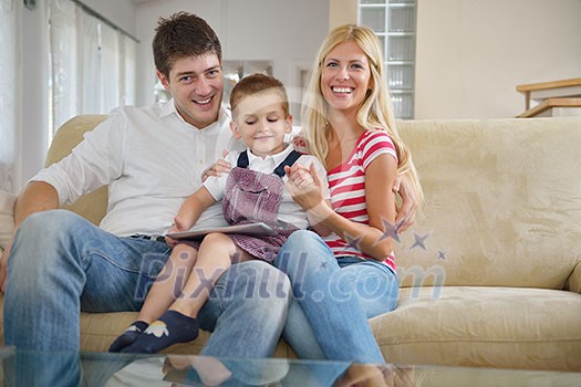 happy young family using tablet computer at modern home for playing games and education happy young family using tablet computer at modern home for playing games and education