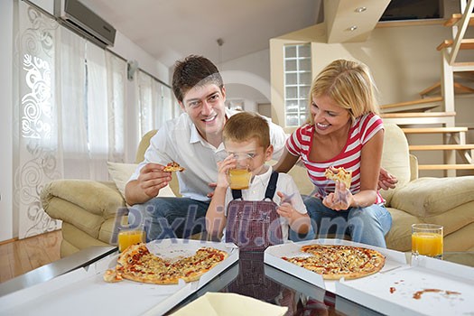 happy young family eating tasty pizza with cheesa and dring healthy and fresh orange juice happy young family eating tasty pizza with cheesa and dring healthy and fresh orange juice